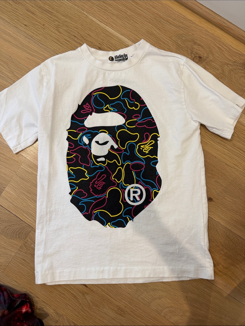 A Bathing Ape Kids White Graphic Tee with Neon Camo Ape Head